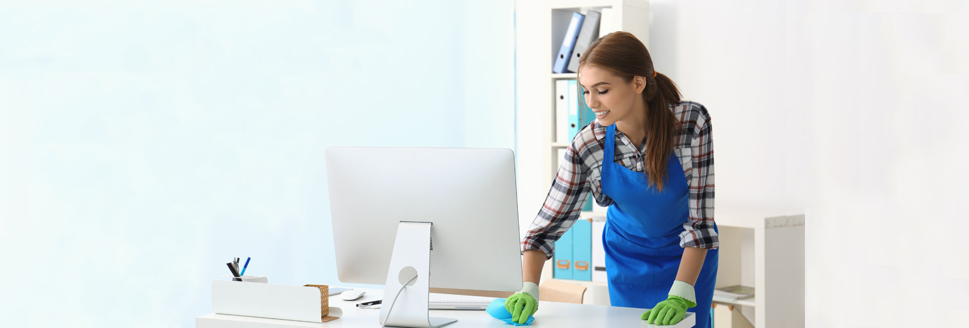 Woman Cleaning Workspace